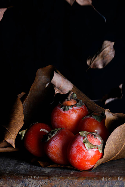 A vertical shot of red tomatoes isolated on the black background - 写真・画像