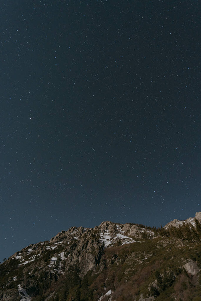 A beautiful view of a starry sky over the mountain - Fotó, kép