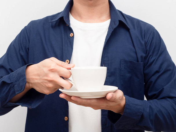 Crop body of man holding coffee cup in hand portrait - 写真・画像