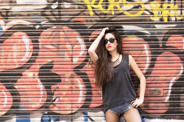 Beautiful woman on urban background, rock lifestyle concept. - Photo, Image