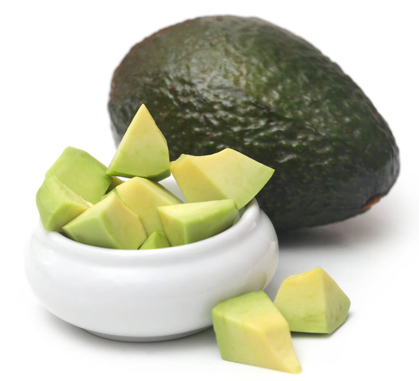 Fresh avocado with pieces over white background - Photo, Image