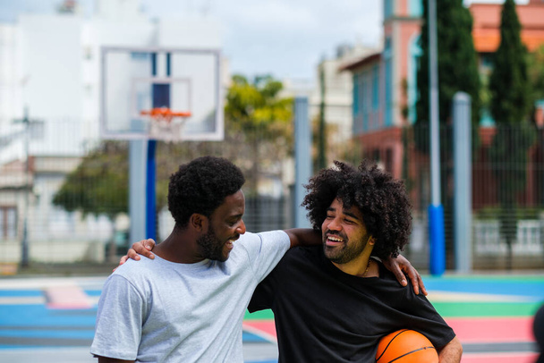 Two young friends having fun playing basketball - 写真・画像
