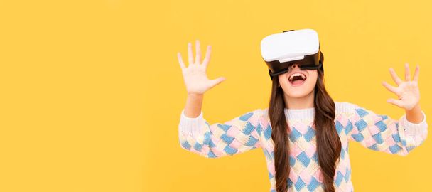happy teen girl wear vr glasses using future technology for education in virtual reality, innovation. Banner of child girl with virtual reality vr headset, studio portrait with copy space - Photo, Image