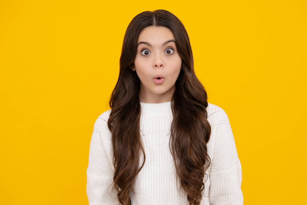 Surprised teenager girl. Teenager child girl with shocked facial expression. Surprised face expression, isolated on yellow background. Funny surprise - Foto, imagen
