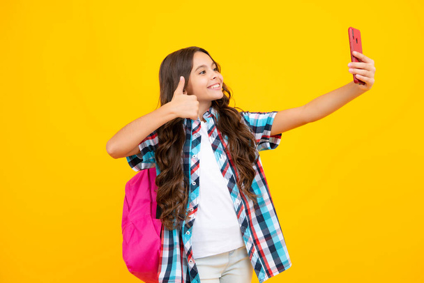Teini-ikäinen koululainen tyttö matkapuhelimella eristetyllä taustalla - Valokuva, kuva