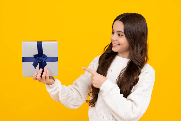 Teenager child with gift box. Present for holidays. Happy birthday, Valentines day, New Year or Christmas. Kid hold present box. Happy face, positive and smiling emotions of teenager girl - Фото, изображение