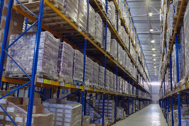 Narrow aisle warehouse with pallet storage system. - Zdjęcie, obraz
