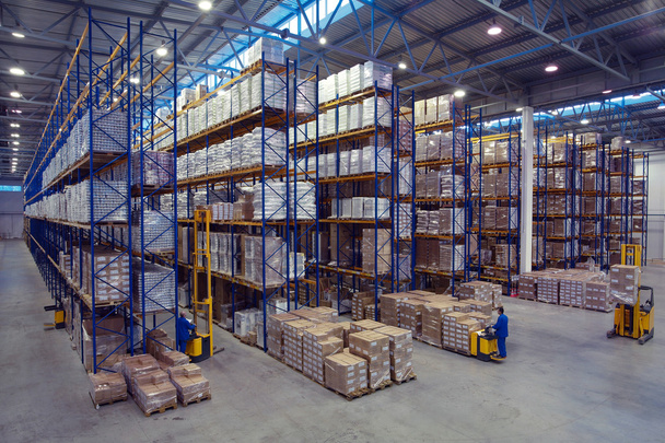 Palletising with foodstuffs stand on a rack shelf goods warehouse. - Photo, image