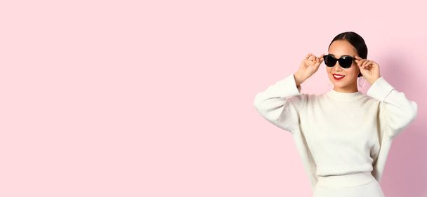 Fashionable young Asian woman on pink background with space for text - Photo, Image