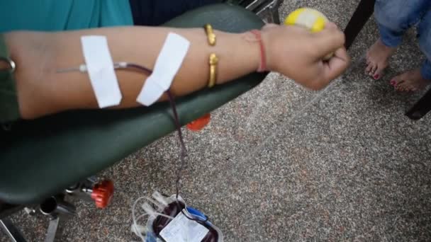 Doador de sangue no campo de doação de sangue realizada com uma bola saltitante segurando na mão no Templo Balaji, Vivek Vihar, Delhi, Índia. Também imagem conceitual para o dia mundial do doador de sangue em 14 de junho todos os anos - Filmagem, Vídeo