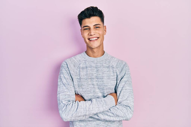 Young hispanic man wearing casual clothes happy face smiling with crossed arms looking at the camera. positive person.  - Valokuva, kuva