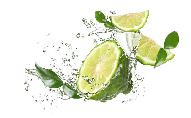 Fresh ripe bergamot fruits, green leaves and splashing water on white background - Fotó, kép