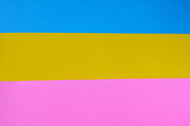 A wallpaper of blue and yellow and pink papers - Fotografie, Obrázek