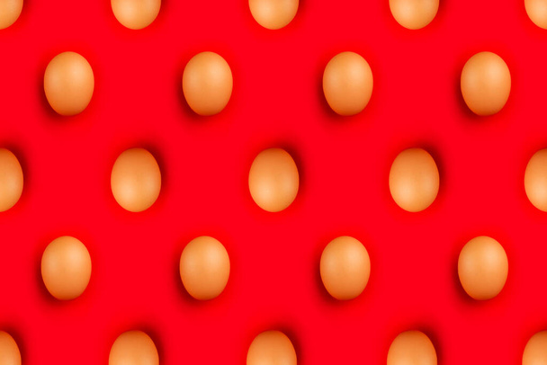 The brown Easter eggs isolated on vibrant red background - Valokuva, kuva