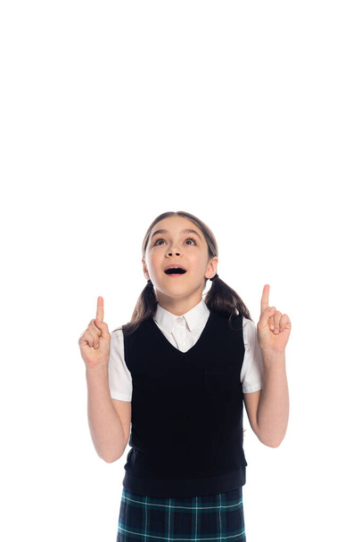 Excited schoolgirl pointing with fingers isolated on white  - Фото, зображення