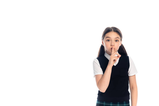 Schoolkid showing secret gesture isolated on white  - Foto, afbeelding