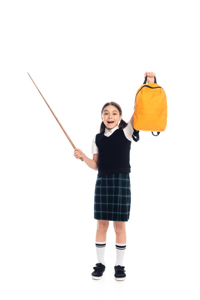 Excited schoolkid holding backpack and pointer on white background - 写真・画像