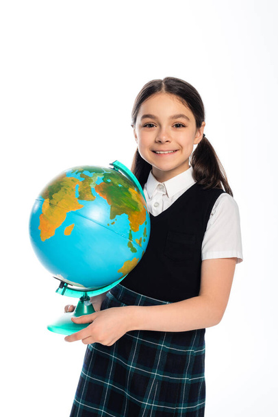 Portrait of cheerful schoolkid holding globe and looking at camera isolated on white  - Foto, Bild