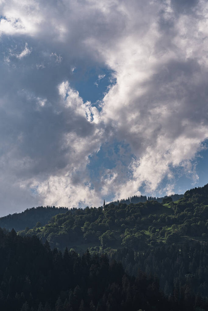 A vertical shot of the cloudy blue sky over Switzerland Falera Graubunden Grisons in summer - Fotoğraf, Görsel