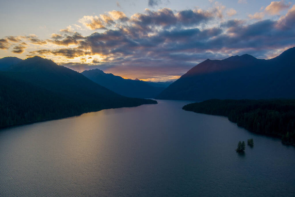 A aerial shot of a Lake Cushman and the Olympic Mountains of Washington state at sunset - Фото, изображение