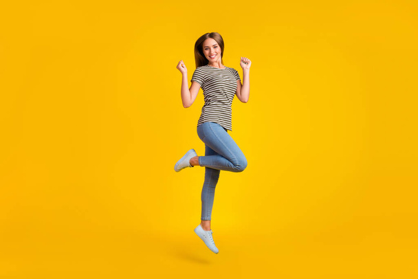 Full length photo of astonished satisfied person jump raise fists triumph luck isolated on yellow color background. - Foto, Imagem