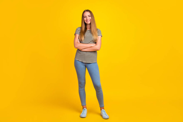 Full size photo of cheerful young person crossed arms beaming smile isolated on yellow color background. - Fotó, kép
