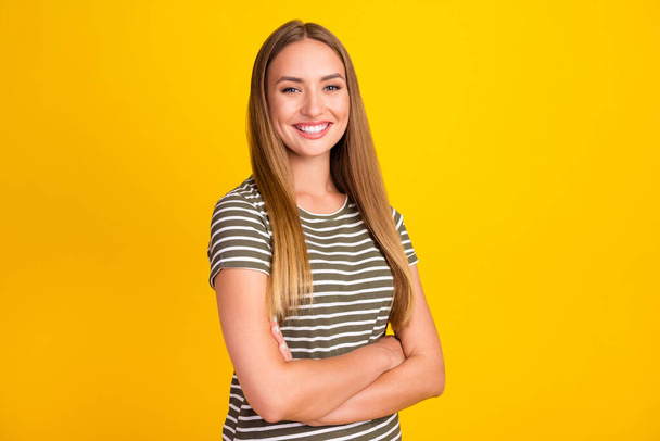 Portrait of half turned cheerful successful lady folded arms beaming smile isolated on yellow color background. - Photo, Image