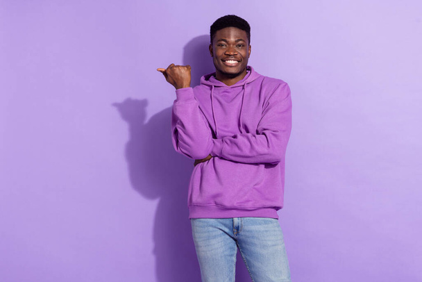 Portrait of positive person toothy smile direct thumb finger empty space isolated on violet color background. - Foto, afbeelding
