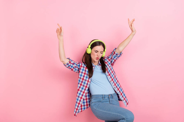 Photo of cheerful overjoyed enjoying music dancing raise hands up isolated on pink color background. - Photo, Image