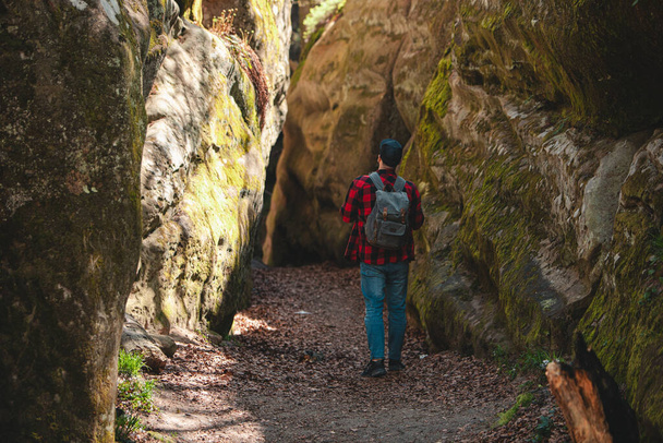 man hiker with backpack walking by trail in canyon dovbush rocks Ukraine - Photo, Image