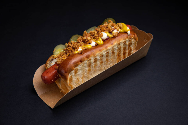 Hot dogs in paper plates with sausages and sauce - Photo, Image