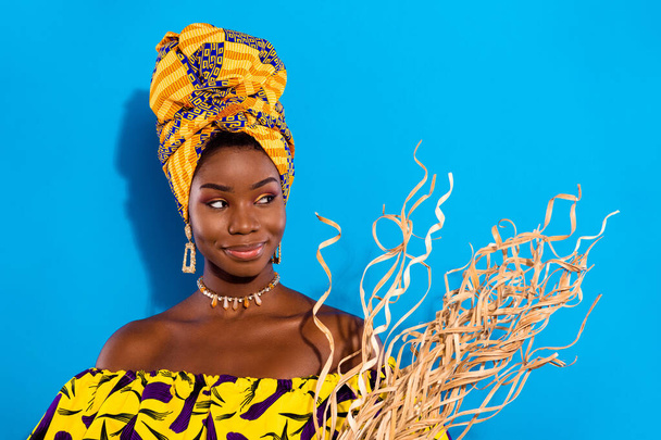 Photo of happy lovely stunning young afro girl look copyspace dreaming hold artificial plant isolated on blue color background. - Φωτογραφία, εικόνα
