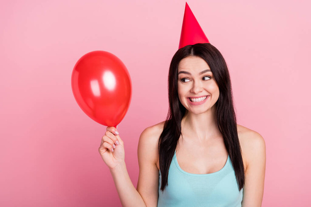 Photo of lovely millennial birthday lady look balloon wear hat blue top isolated on pink background. - Fotó, kép