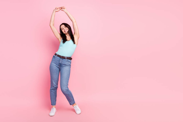 Full size photo of cool millennial lady dance wear blue top jeans sneakers isolated on pink background. - 写真・画像