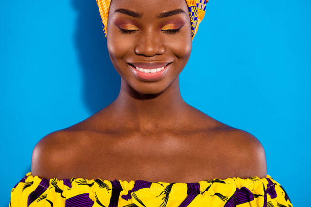 Portrait of pretty positive dark skin lady closed eyes toothy smile have good mood isolated on blue color background. - Foto, Bild