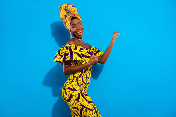 Photo of young happy excited smiling beautiful afro girl raise fists in victory success isolated on blue color background. - Fotó, kép