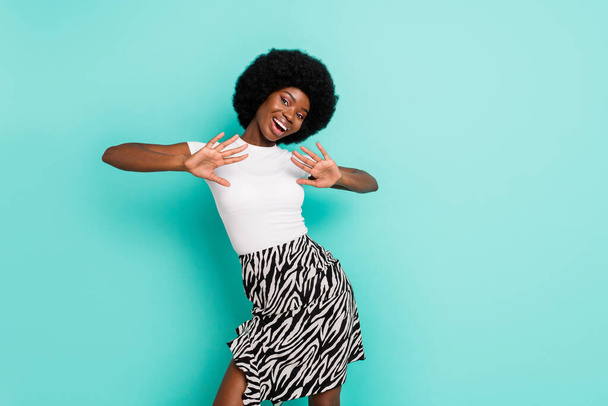 Photo of sweet adorable dark skin woman dressed casual outfit smiling dancing isolated turquoise color background. - Fotografie, Obrázek