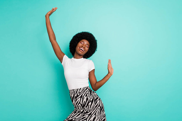 Photo of cheerful happy afro american young woman dance good mood enjoy isolated on teal color background. - Foto, afbeelding
