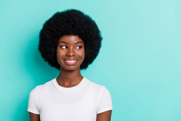 Photo of sweet adorable dark skin woman dressed casual outfit looking empty space smiling isolated turquoise color background. - Φωτογραφία, εικόνα