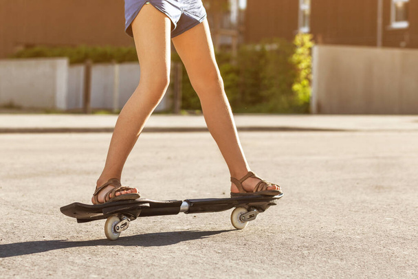 Waveboard Riding, Skateboard Ripstik Caster Riding. Steepest skateboard fashion waveboard "Ripstik Air pro". Teenager legs ride Waveboard. - Photo, Image