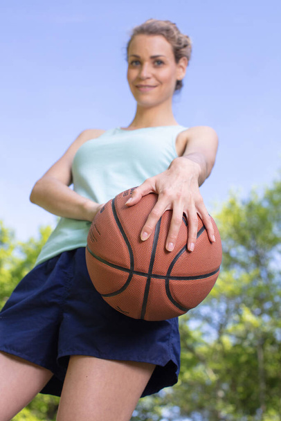 young female basketball player in uniform outdoors - Valokuva, kuva