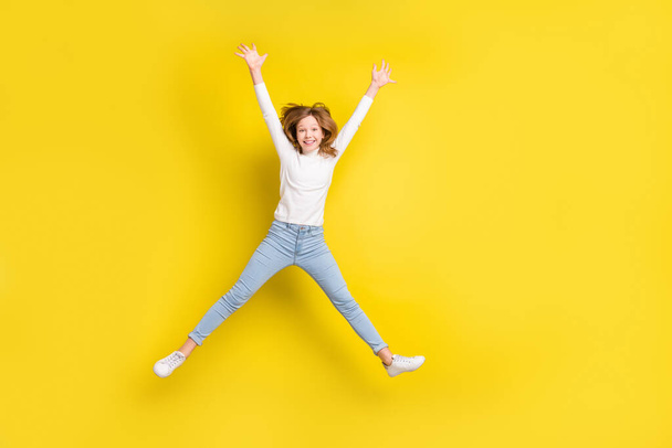 Full length photo of young cheerful girl happy positive smile have fun jump up isolated over yellow color background. - Foto, Imagem