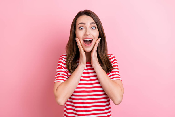 Photo of young excited girl happy positive smile hands touch cheeks amazed news isolated over pink color background. - 写真・画像