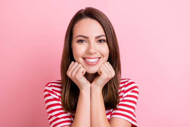 Photo of young attractive woman happy positive smile hands touch chin dream isolated over pink color background. - Foto, immagini