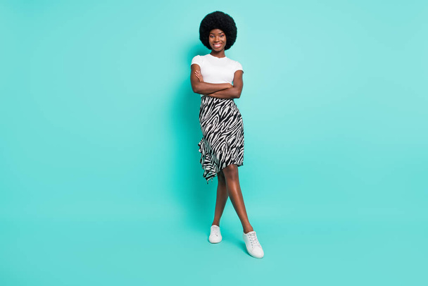 Photo of shiny charming dark skin woman dressed casual outfit smiling hands crossed isolated turquoise color background. - Fotó, kép