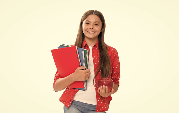 happy schoolgirl with copybook. teen girl with notebook. back to school. child with apple lunch ready to study. healthy childhood. kid going to do homework. teenager student. high school education. - Photo, Image