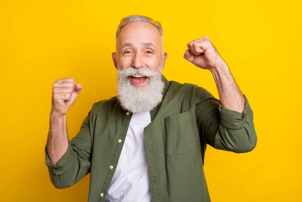 Photo portrait of grandfather gesturing like winner laughing isolated vivid yellow color background. - Valokuva, kuva