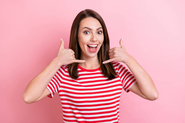 Photo of impressed young brunette lady ask to call wear red t-shirt isolated on pink color background. - Foto, Bild