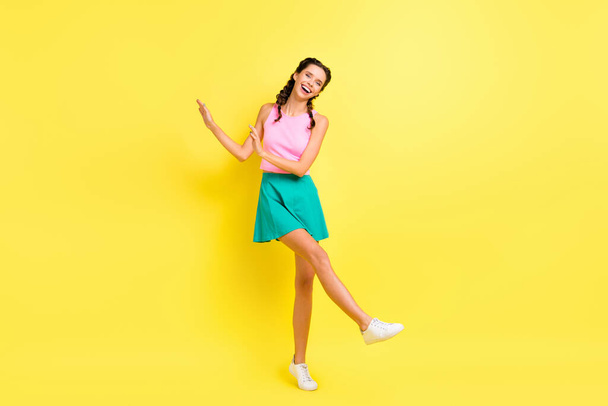 Full size photo of optimistic cool brunette lady dance wear pink top blue skirt isolated on vivid yellow color background. - Фото, зображення