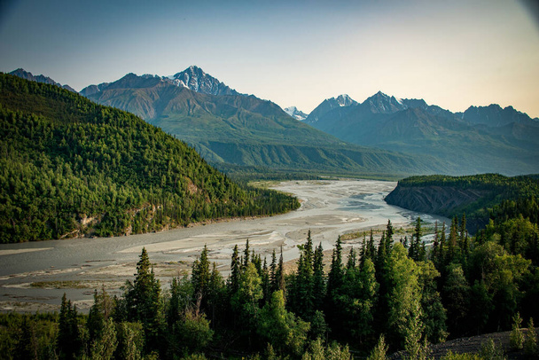 A beautiful view of a river surrounded by trees and mountains - Photo, image